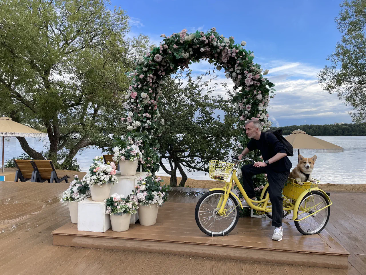 08-Alexey on a stationary yellow 3 wheel bike with Trudi sitting in a trunk behind him.jpg