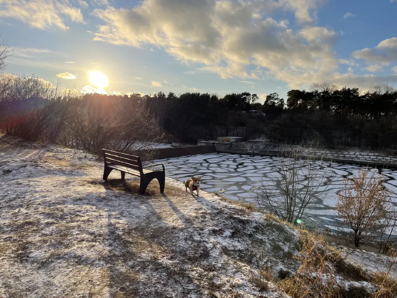 09-Trudi near a bench on a hill with a frozen river in the background.jpg